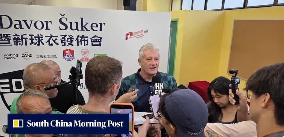 Davor Šuker speaking at a press event surrounded by reporters