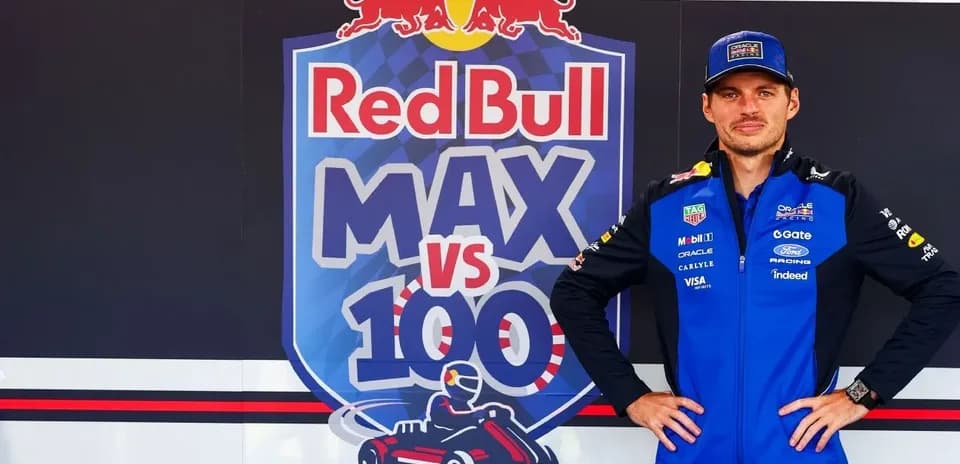 Driver posing in front of Red Bull promotional banner