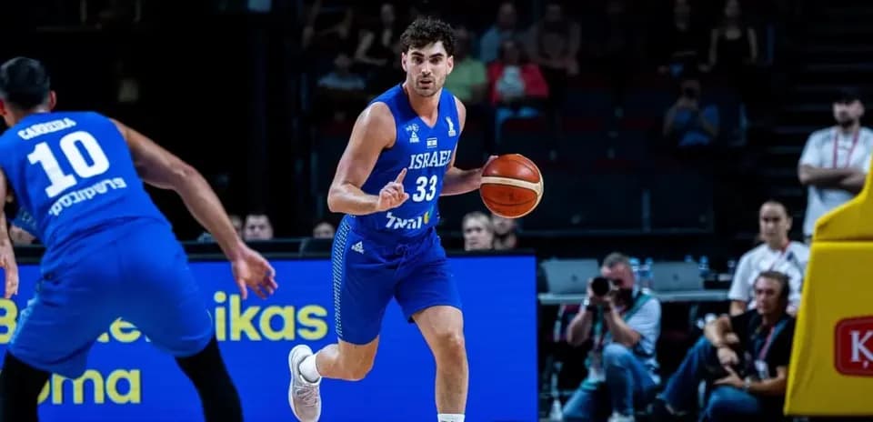 Israeli player dribbling basketball during game