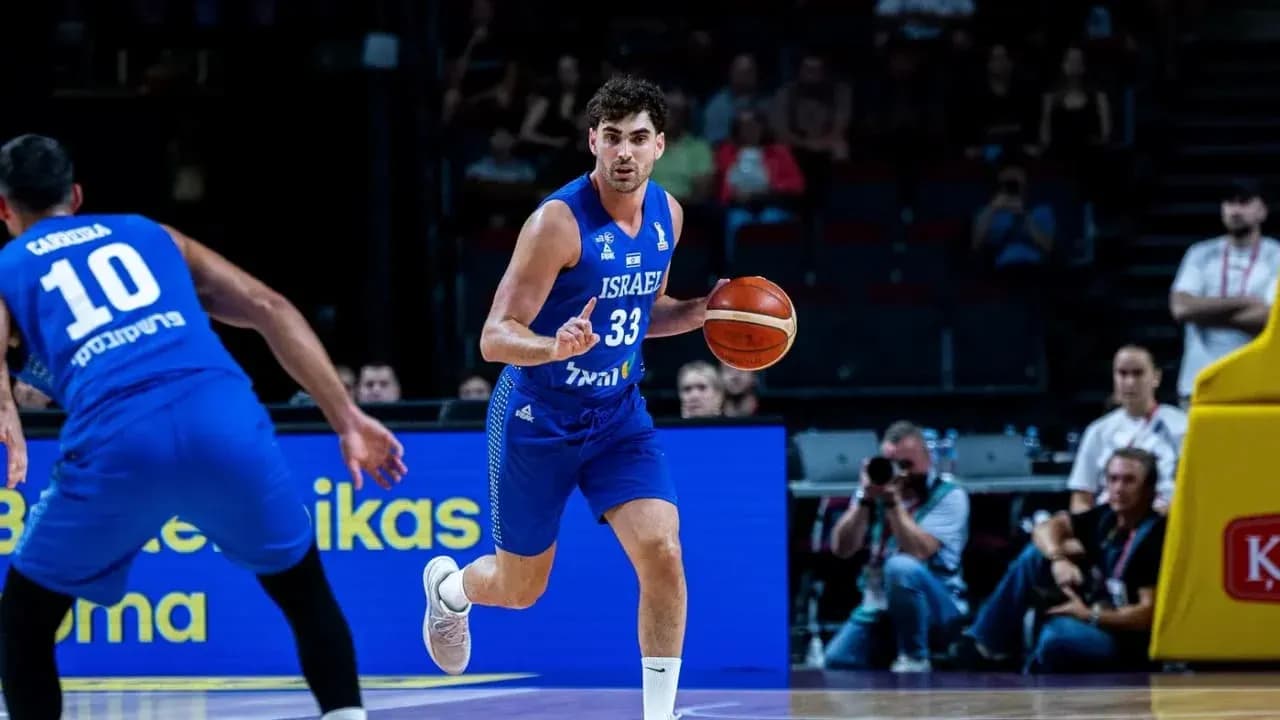 Israeli player dribbling basketball during game