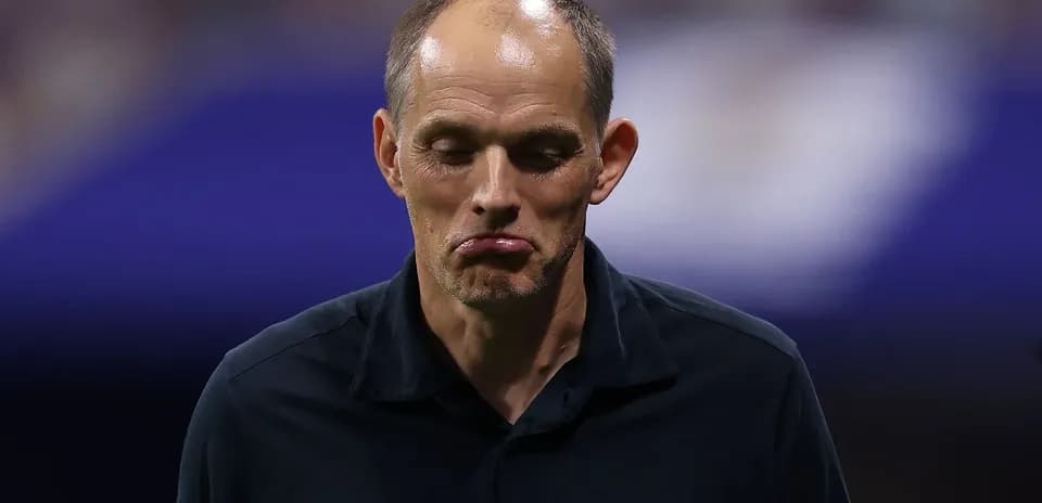 Coach walking off the pitch after match