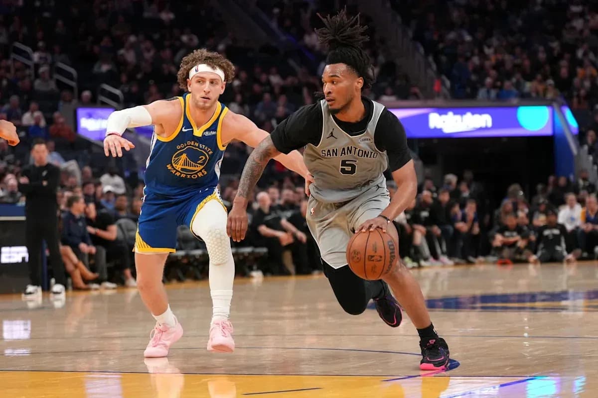 San Antonio player dribbling past Golden State defender