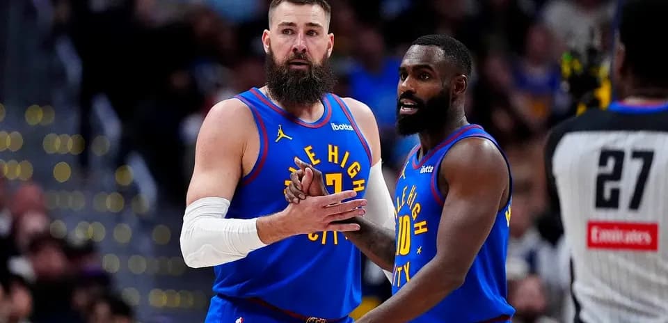 Two players discussing strategy during basketball game