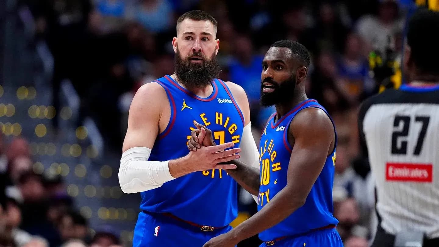 Two players discussing strategy during basketball game