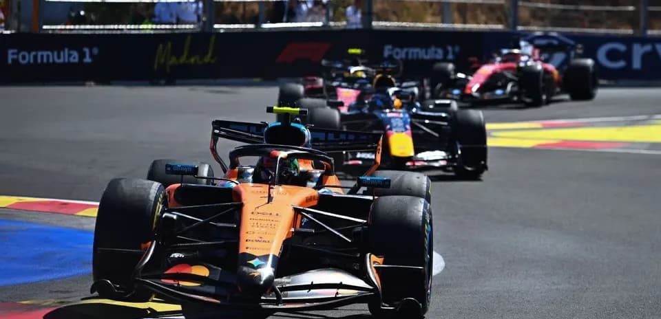 Four Formula 1 cars racing on a circuit