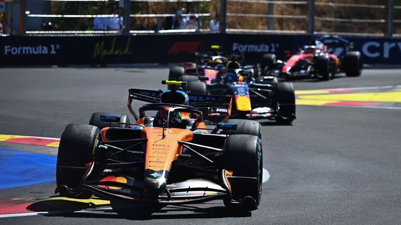 Four Formula 1 cars racing on a circuit