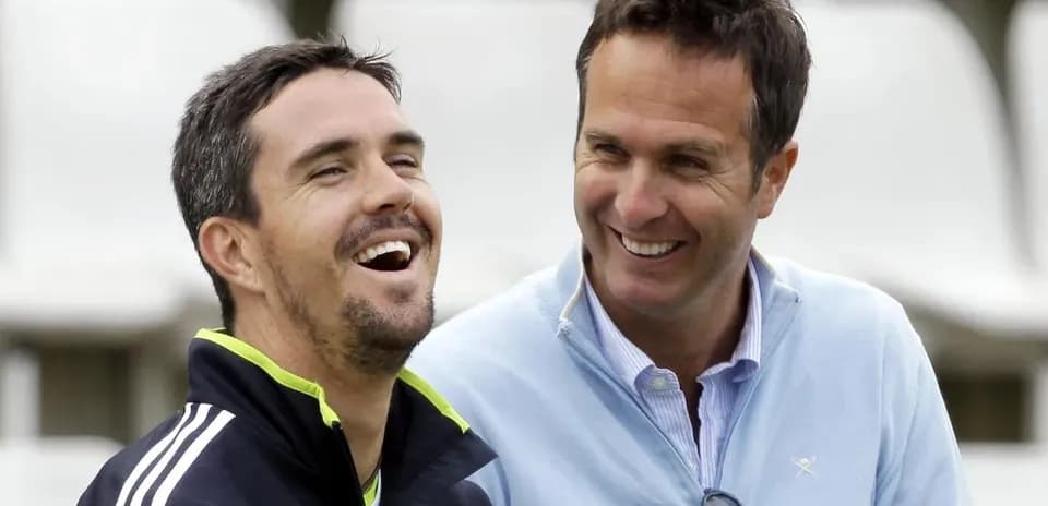 Two cricket players laughing during an informal moment