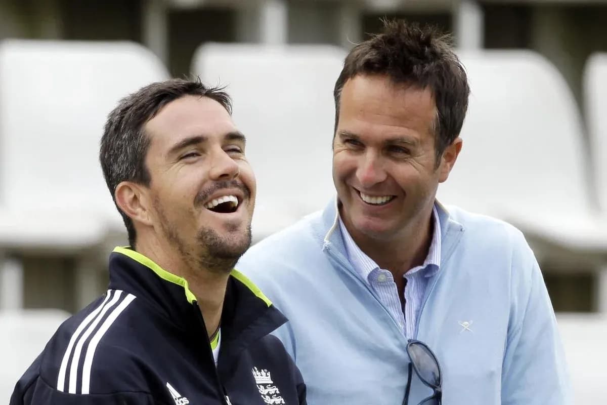 Two cricket players laughing during an informal moment
