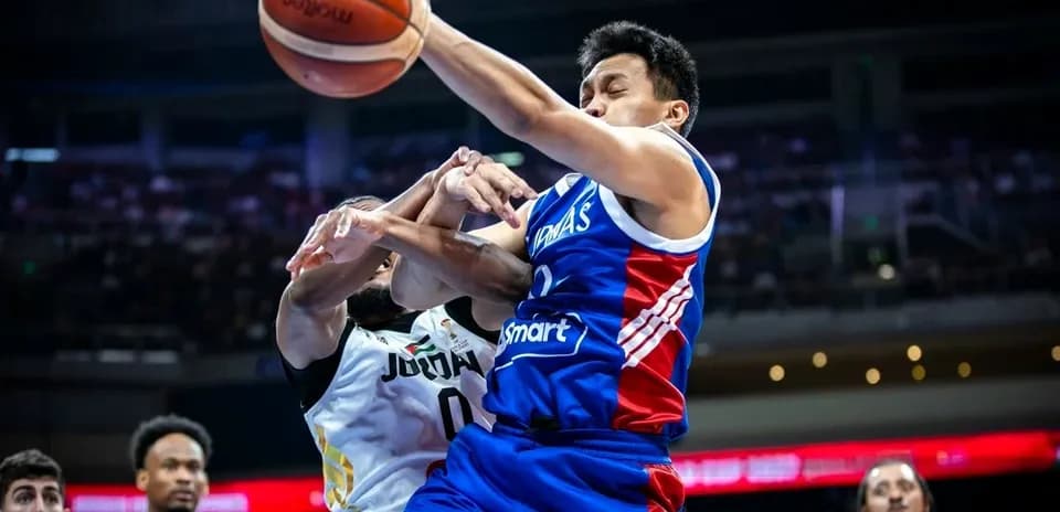 Player from Philippines contesting ball against Jordan opponent
