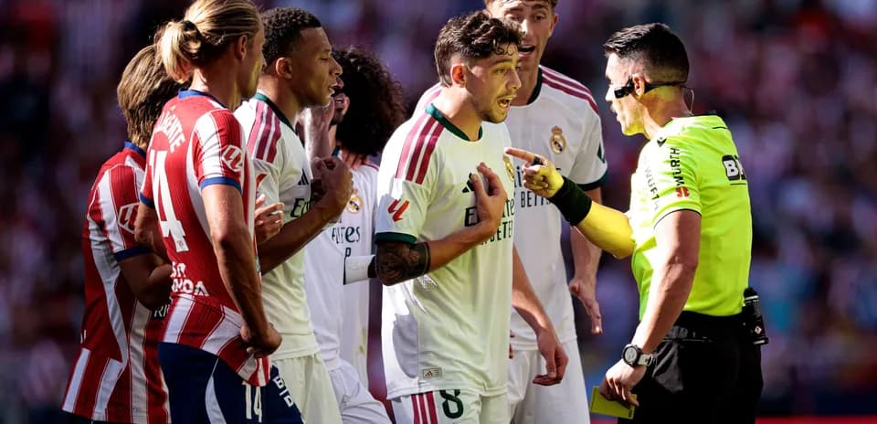 Players arguing with referee during intense match