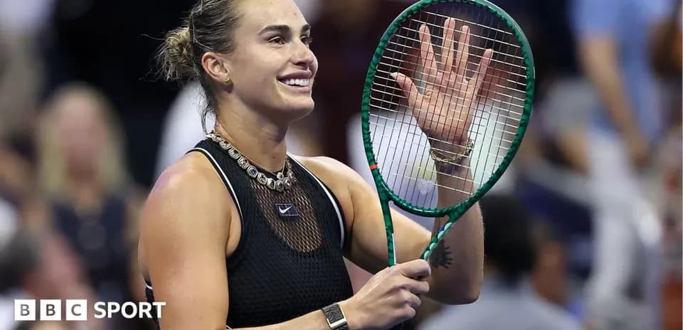 Tennis player waving with racket at audience