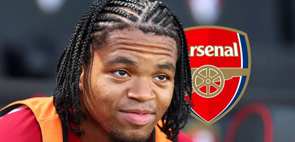 Player with braided hair sitting near Arsenal logo
