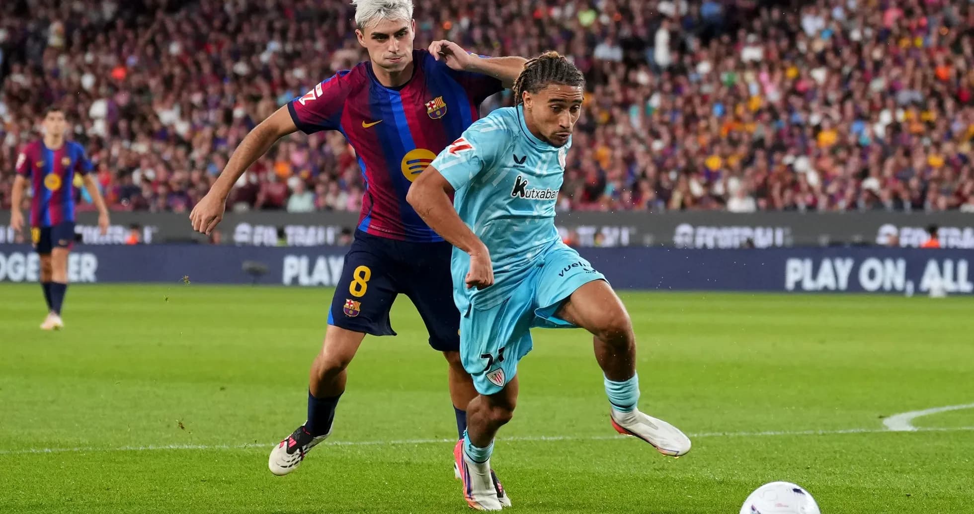 Player from Barcelona tackles opponent during match