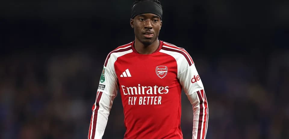 Arsenal player wearing red jersey on the field