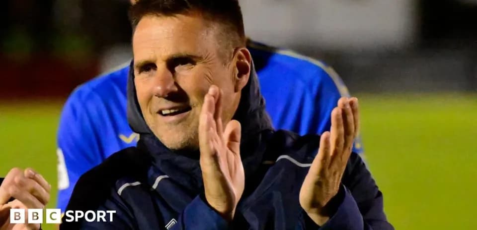 Coach applauding during post-match celebrations
