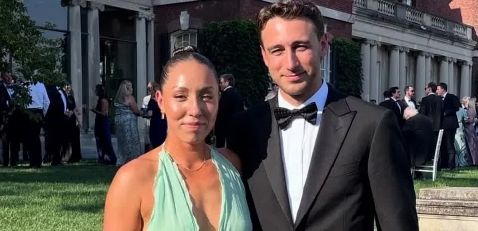 Couple posing together at outdoor formal event