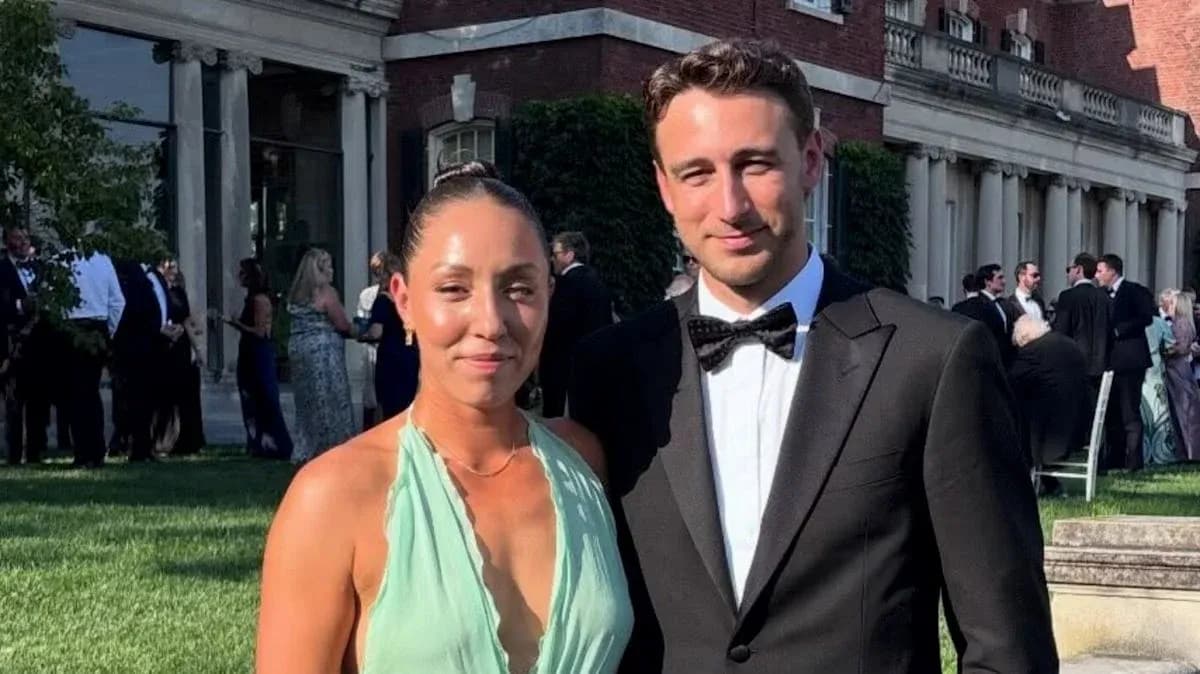 Couple posing together at outdoor formal event