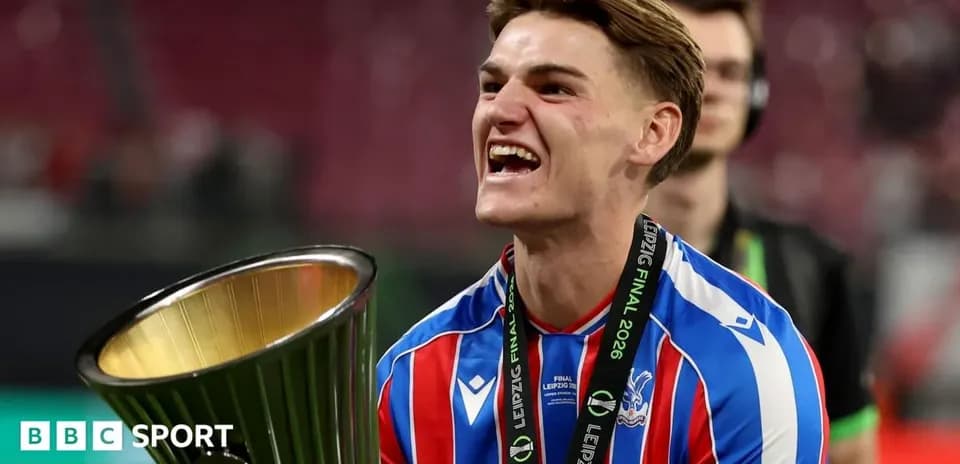 Player celebrating with trophy after match victory