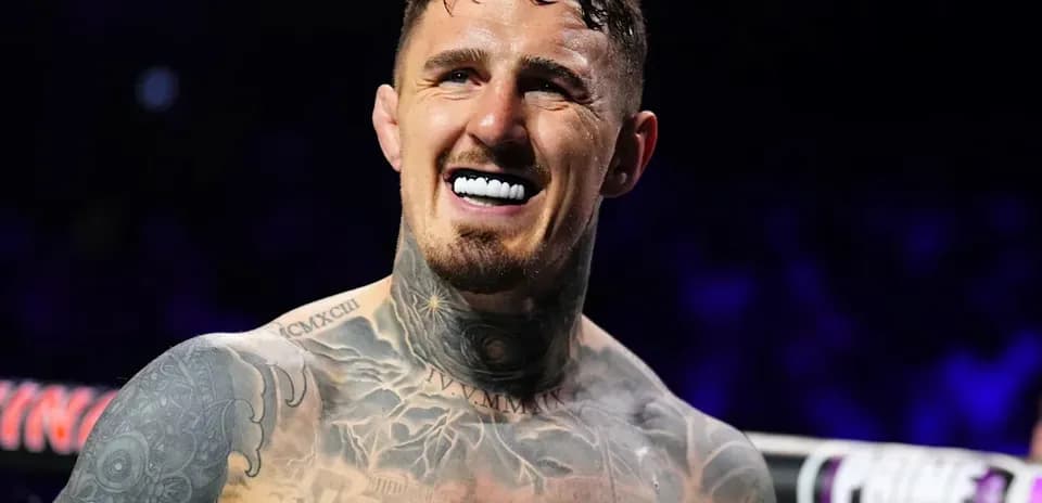 Boxer smiling with tattoos in the ring