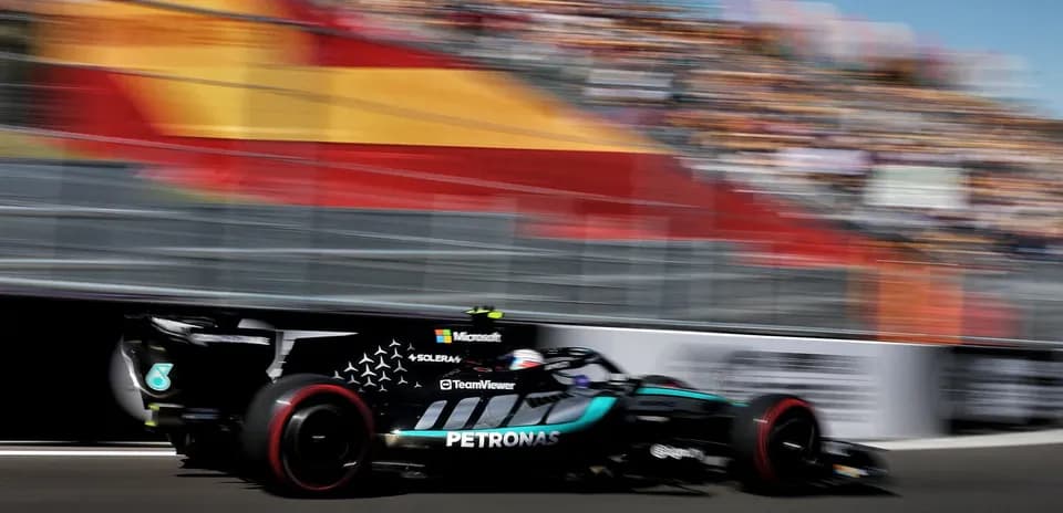Formula 1 car speeding past grandstand at race