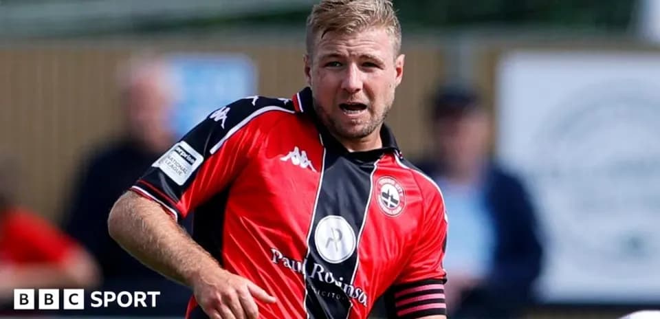 Player in red kit during a football match