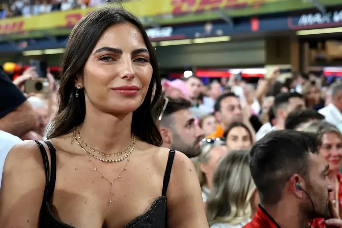 Woman smiling in a crowded stadium setting