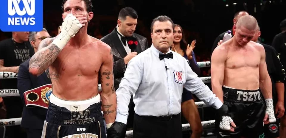 Boxers after match with referee in ring