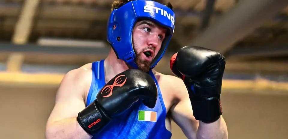 Boxer in blue gear practicing punches during training