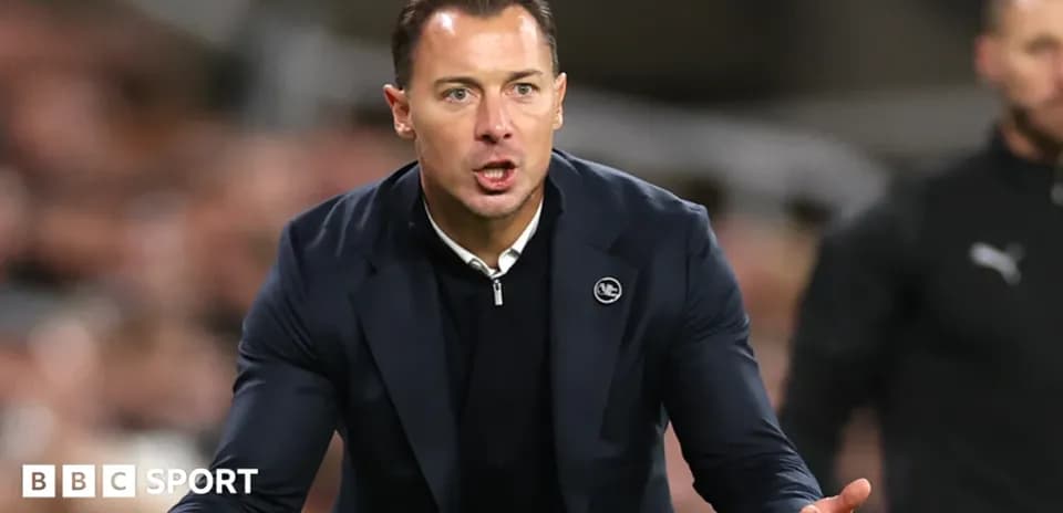 Manager directing players from the sidelines during match