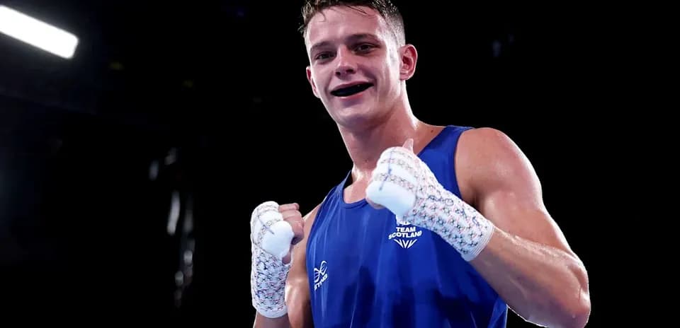 Boxer from Team Scotland celebrating victory in ring