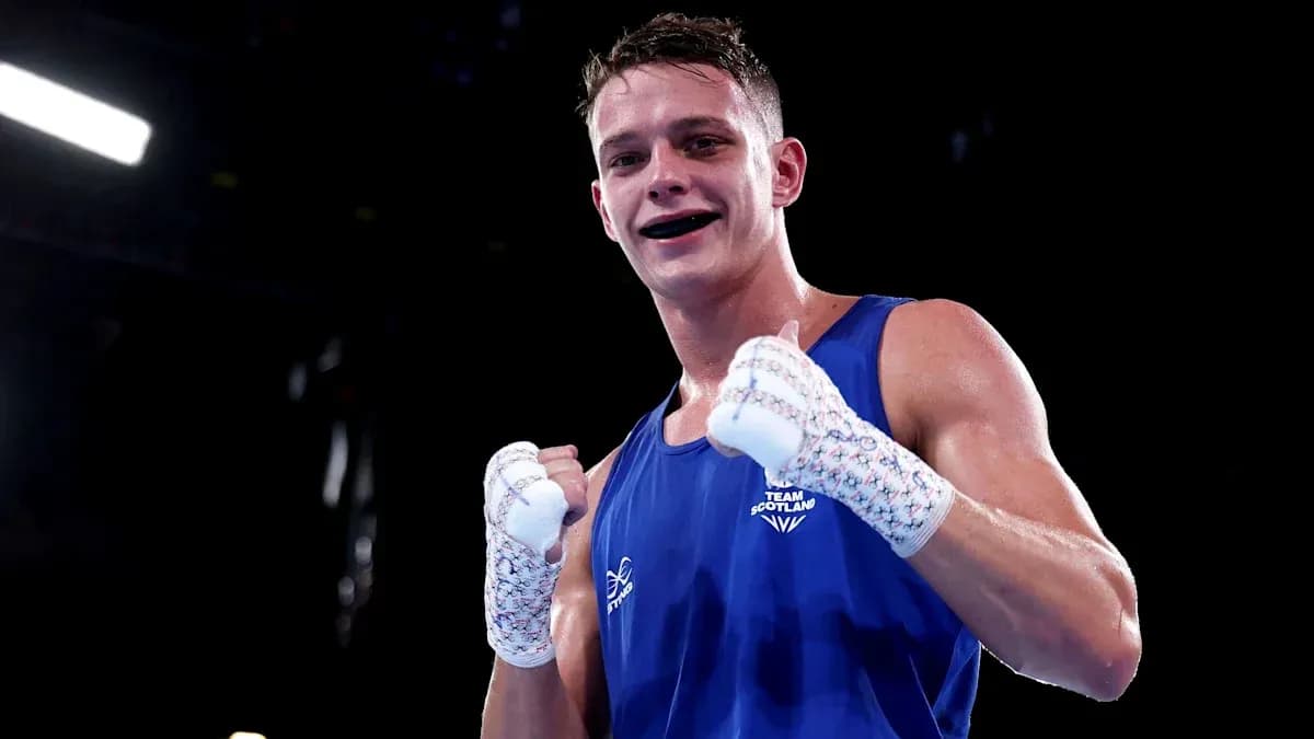 Boxer from Team Scotland celebrating victory in ring