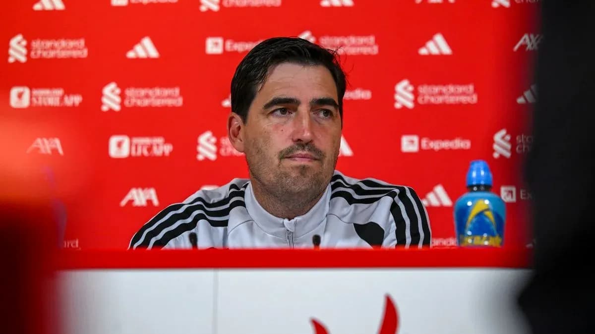 Manager at press conference with red backdrop