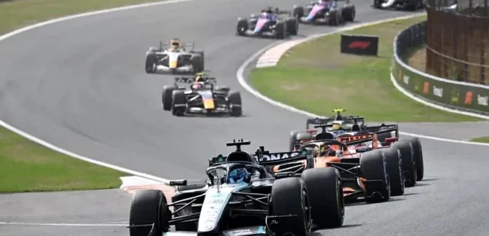 Several Formula 1 cars racing on a track