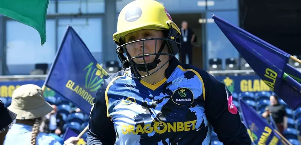 Player in Glamorgan kit entering the field with flags