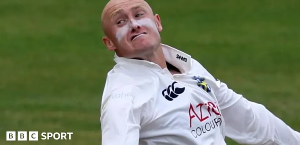 Cricketer delivering a ball on the pitch