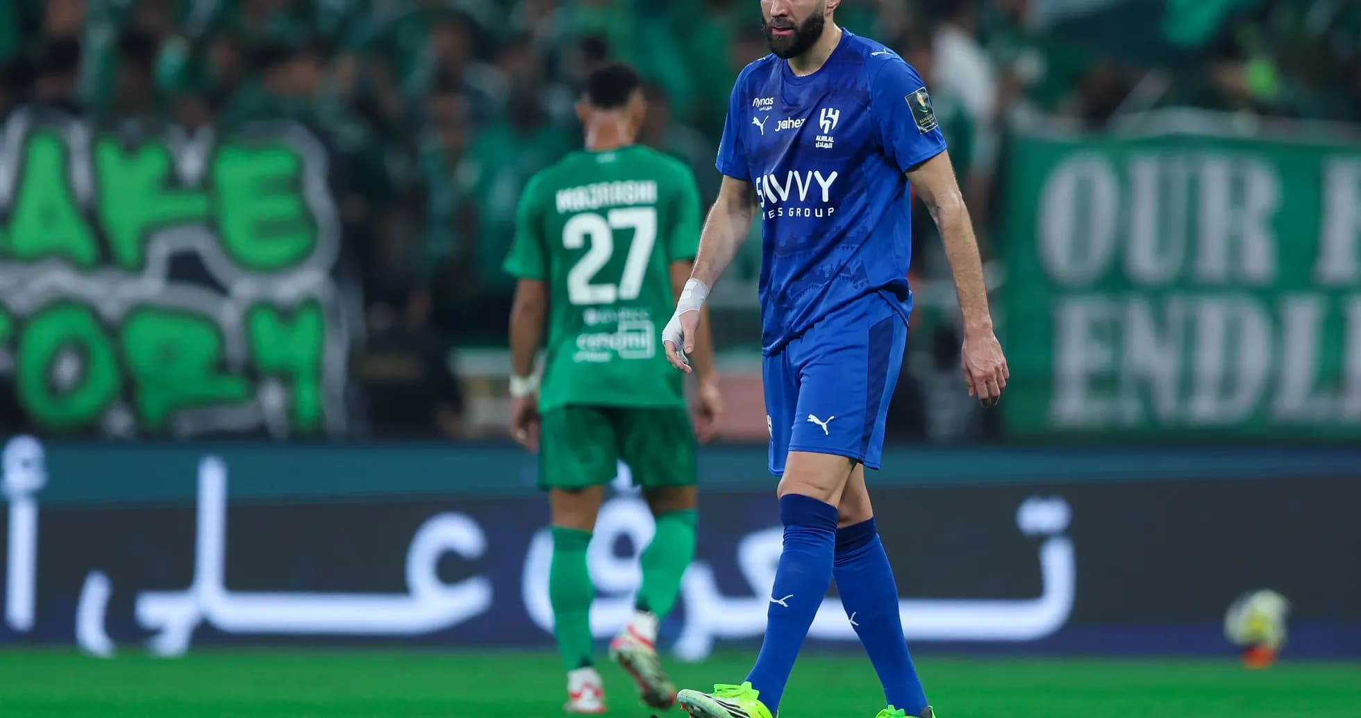 Player in blue jersey walking on the field