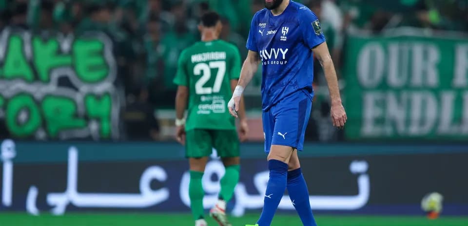 Player in blue jersey walking on the field