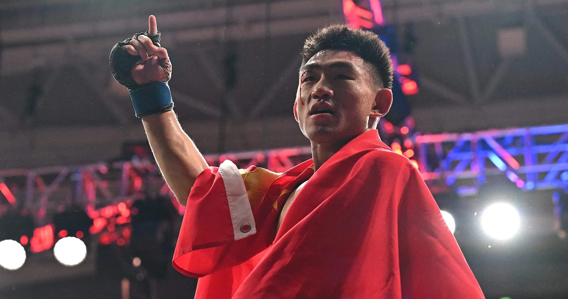 Boxer celebrating victory with a flag raised