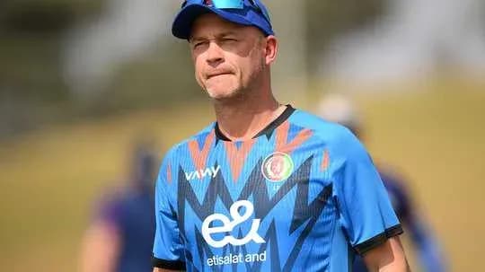 Coach wearing Afghanistan training kit on field