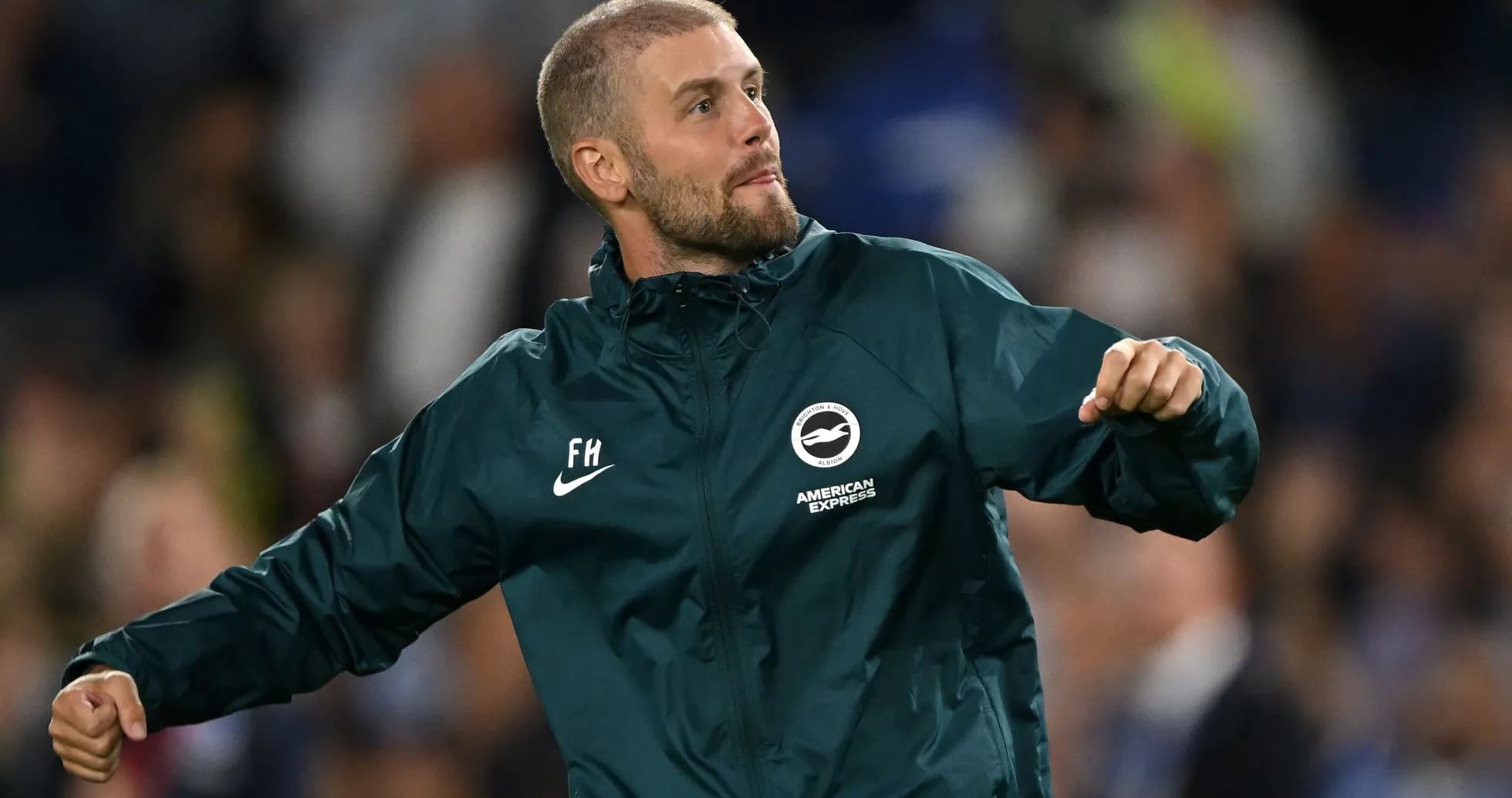 Coach celebrating on the sidelines during a match