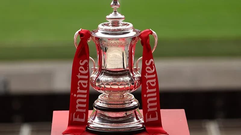 Emirates FA Cup trophy displayed on podium
