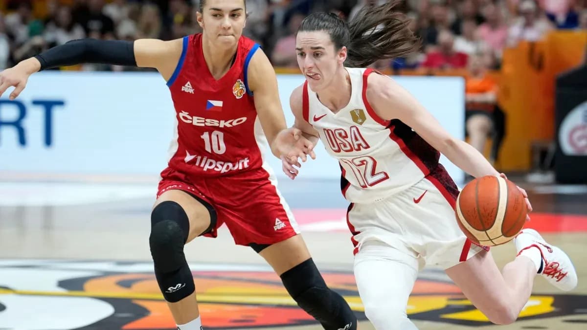 Player from USA dribbling past opponent in red jersey