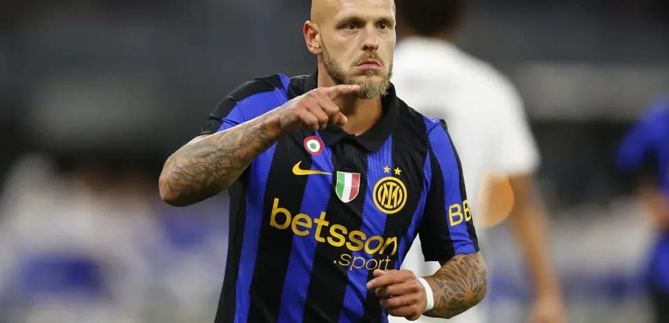 Player in black and blue jersey celebrating on field