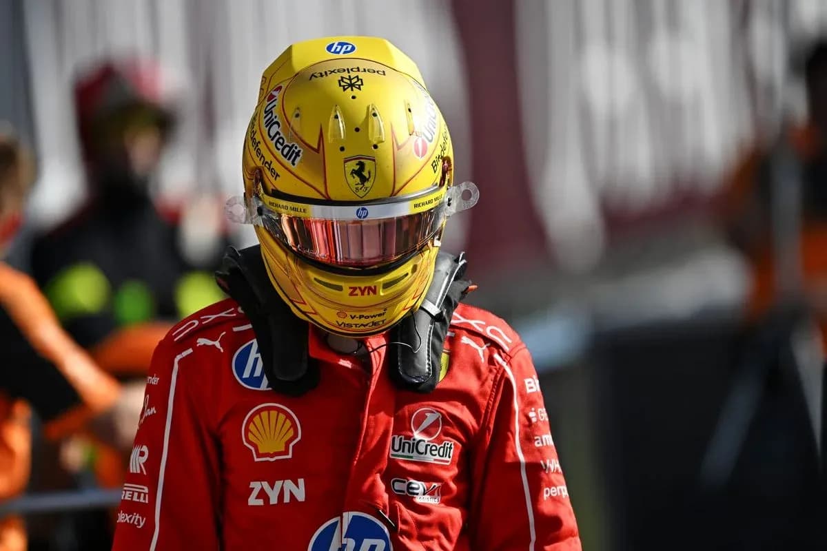 Driver in Ferrari suit and helmet at pit lane