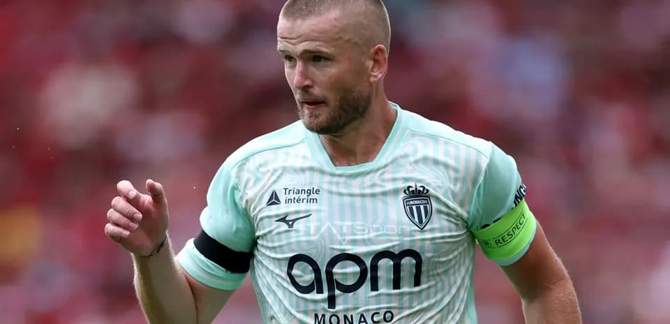 Player in Monaco kit during match action