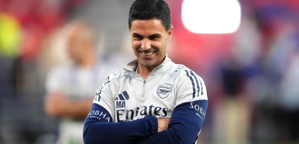 Arsenal manager smiling during match warm-up