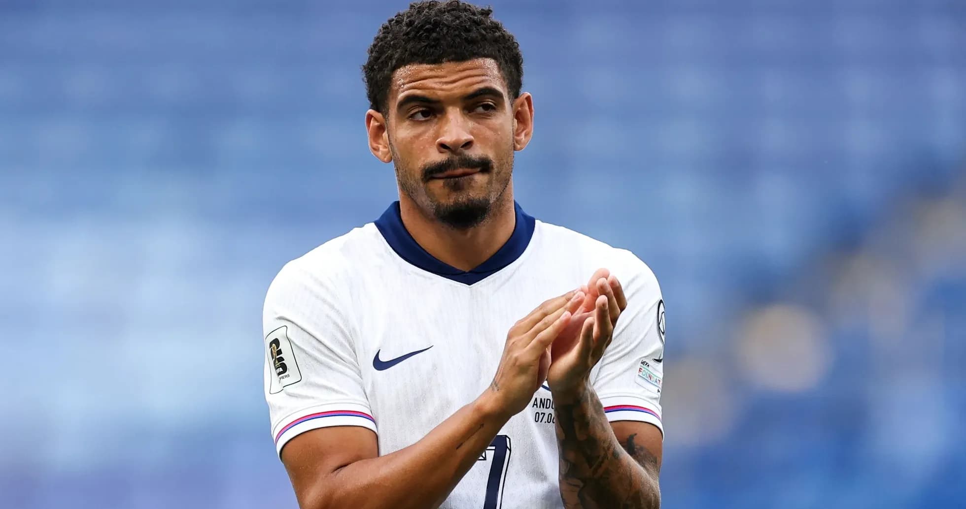 Player applauding fans after a match