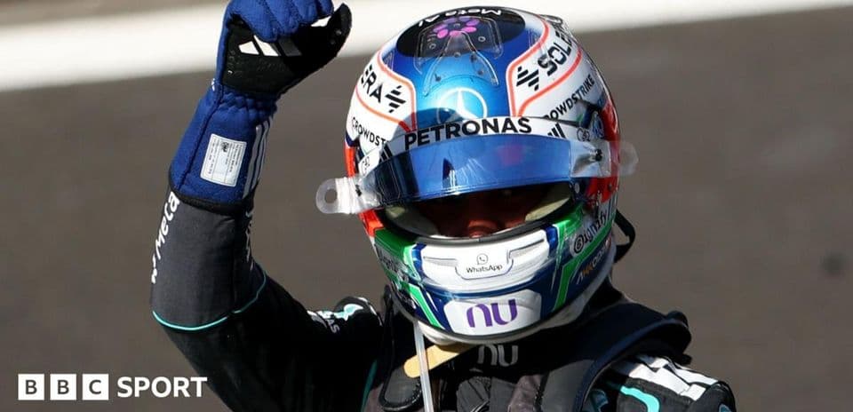 Racing driver celebrating victory with raised fist