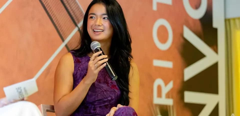Young woman speaking into microphone at event