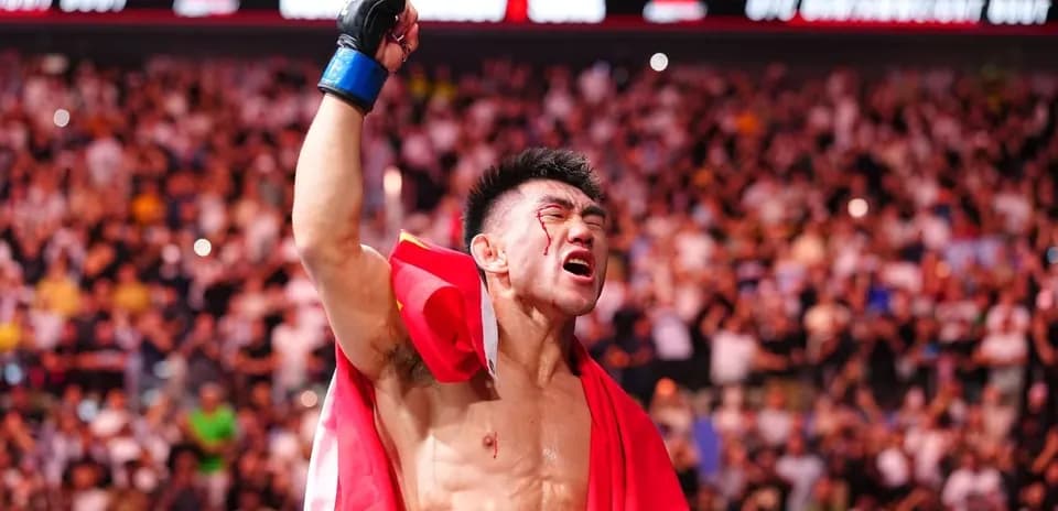 Fighter celebrating victory with raised hand and flag